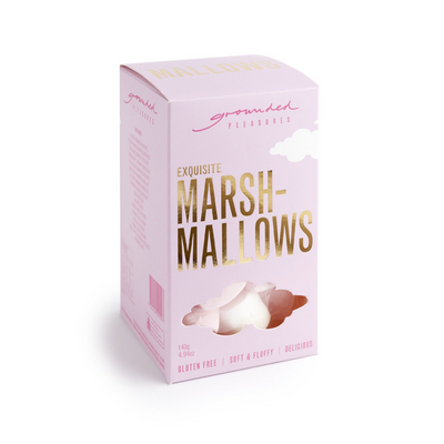 Pink box with gold foil lettering with puffy white and pink marshmallows inside